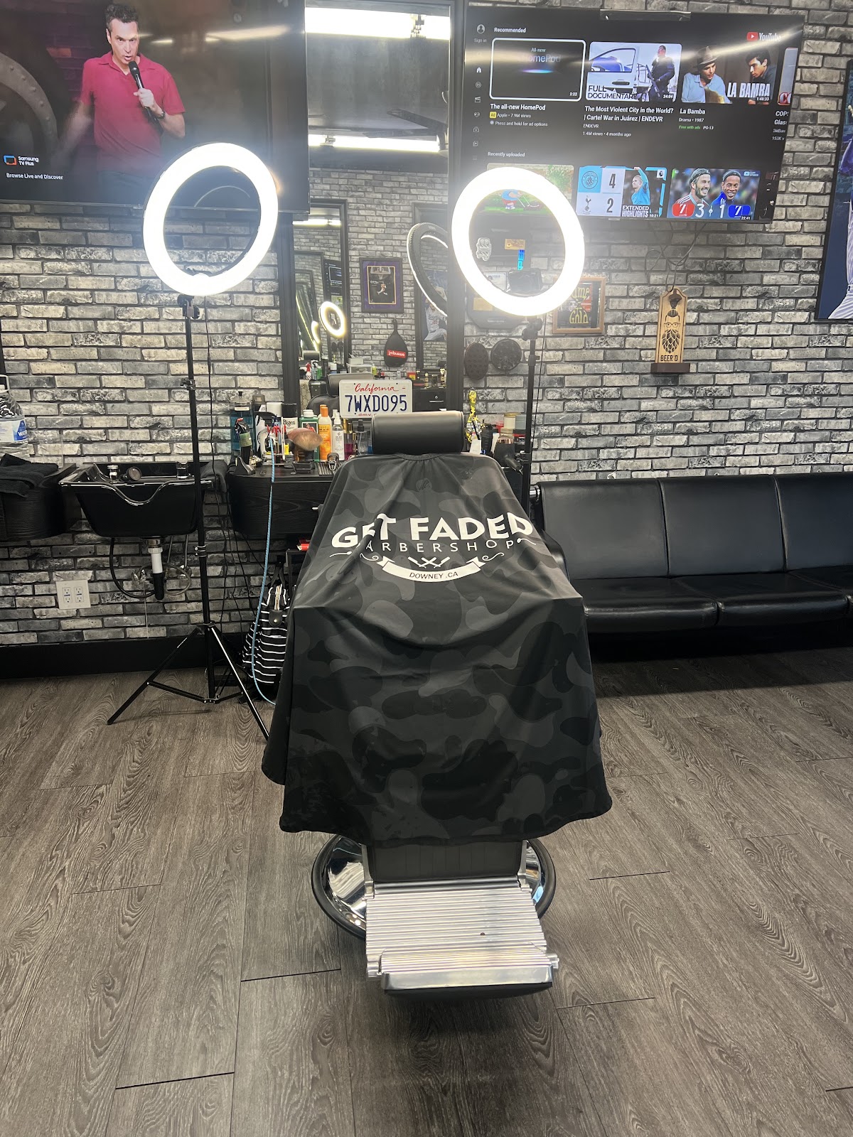 The shop's branded camo cape on the chair between two ring lights