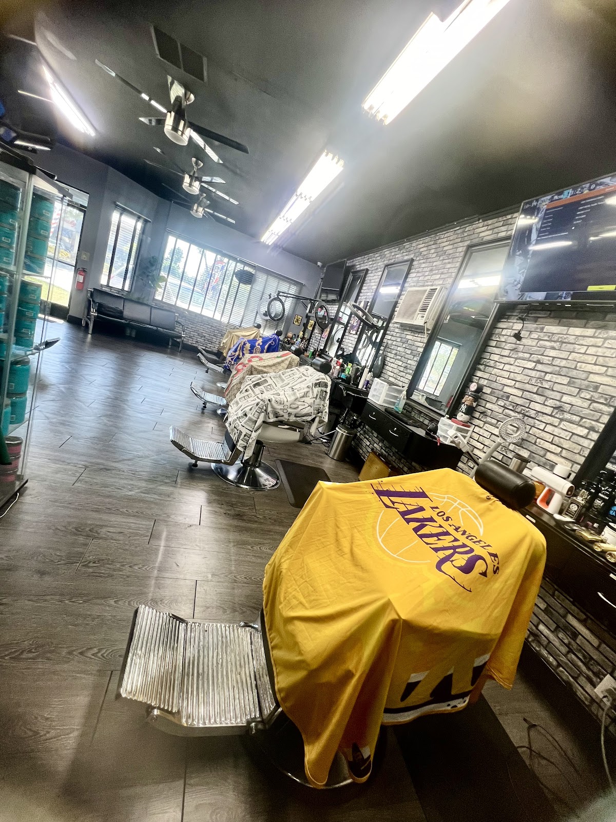 Down the row of chairs with a gold Lakers cape over the bench