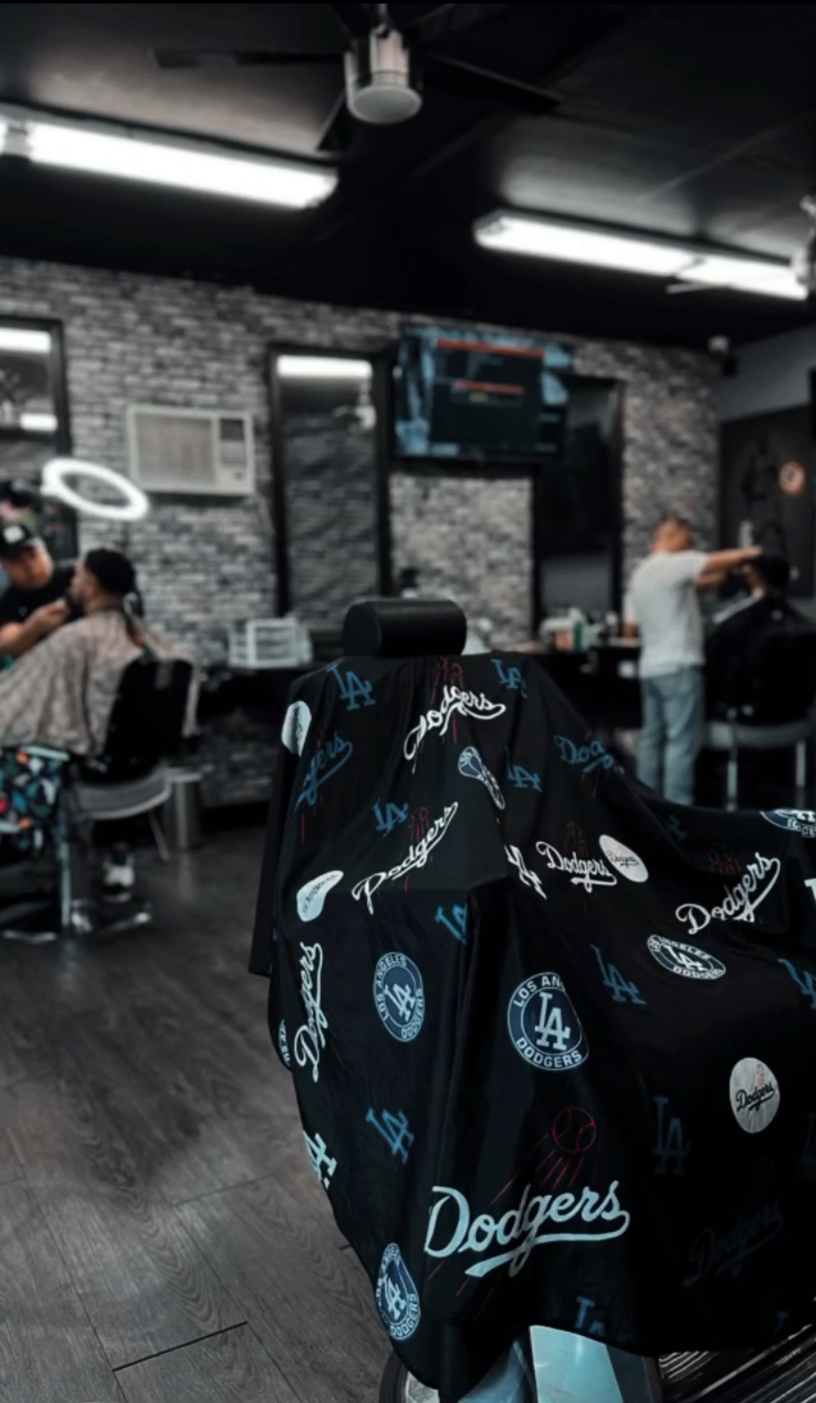 Mid cut in the shop with a Dodgers patterned cape